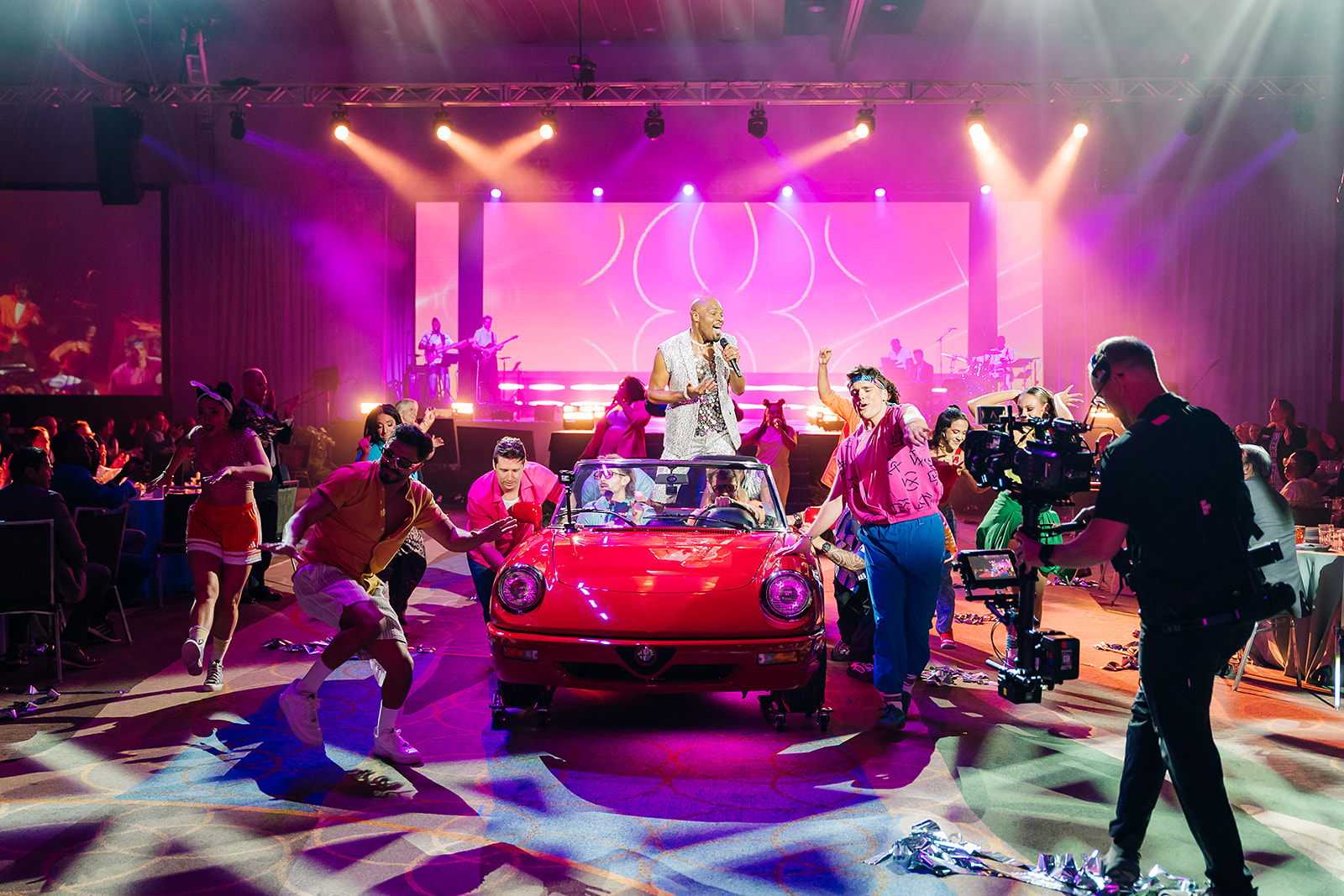 80s themed live performance with red convertible at the Visit Orlando luncheon
