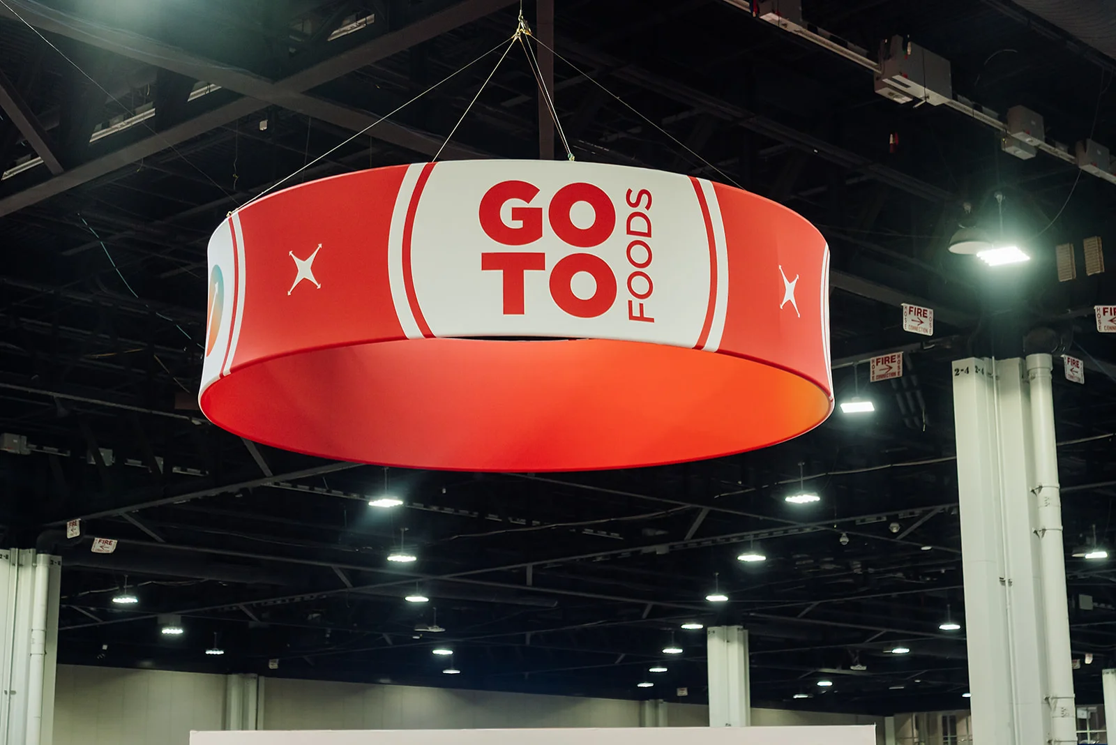 Overhead GoTo Foods branded circular signage hanging in the Georgia World Congress Center expo hall