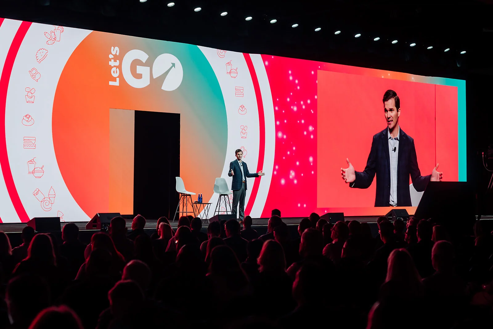 Keynote speaker on the Let's Go main stage with IMAG screen at the GoTo Foods conference in Atlanta