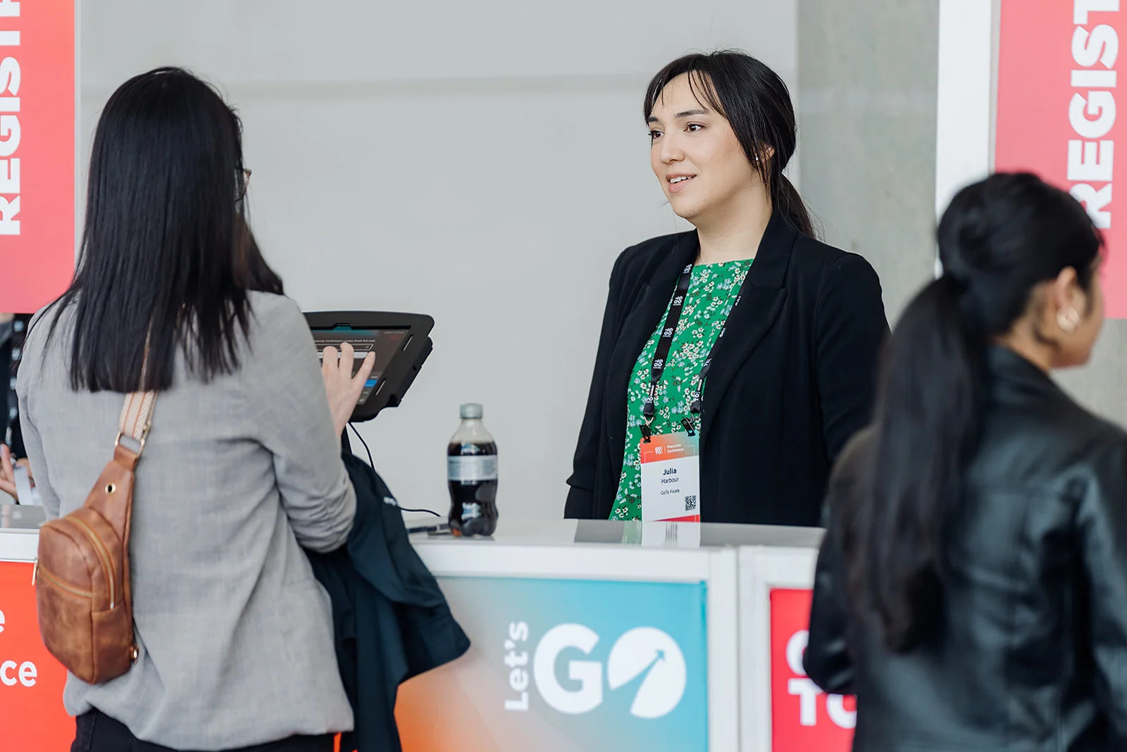 GoTo Foods staff member assisting attendees at the registration desk during the Atlanta conference