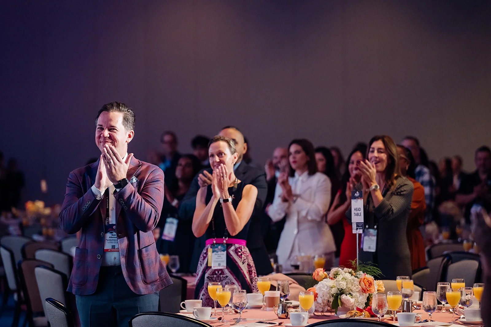 Attendees giving a standing ovation at a USHCC gala ballroom in Atlanta