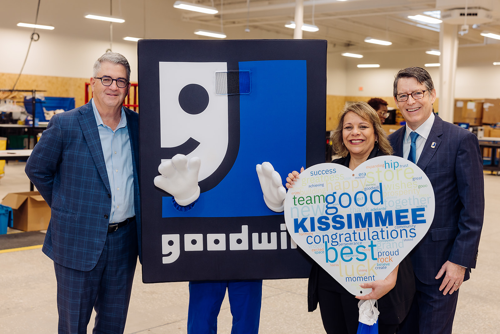 Goodwill of Central Florida CEO posing with the Goodwill mascot at the Kissimmee store opening