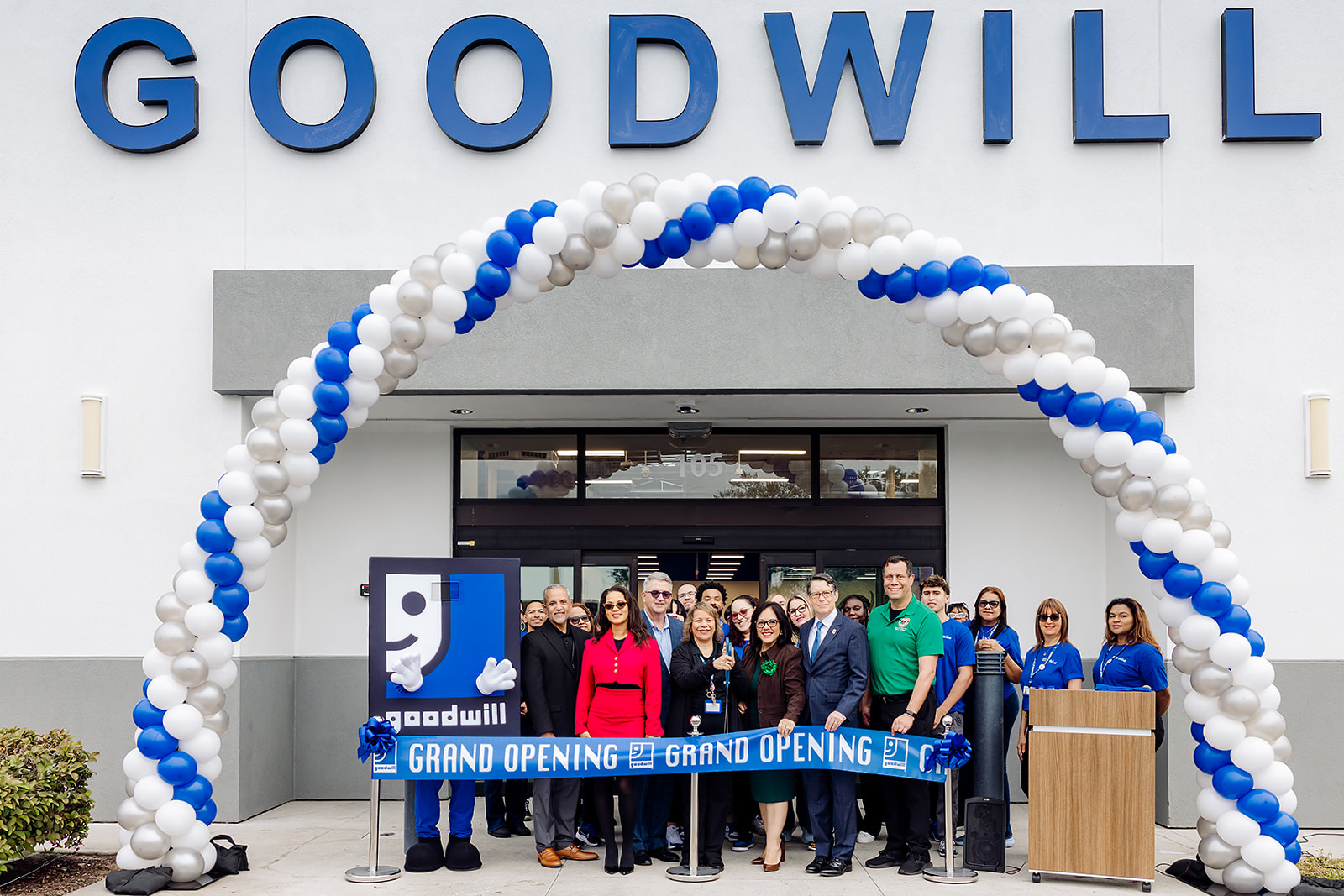 Goodwill of Central Florida Kissimmee store grand opening ribbon cutting under a blue and white balloon arch
