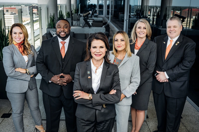 Leadership team group headshot on a downtown rooftop