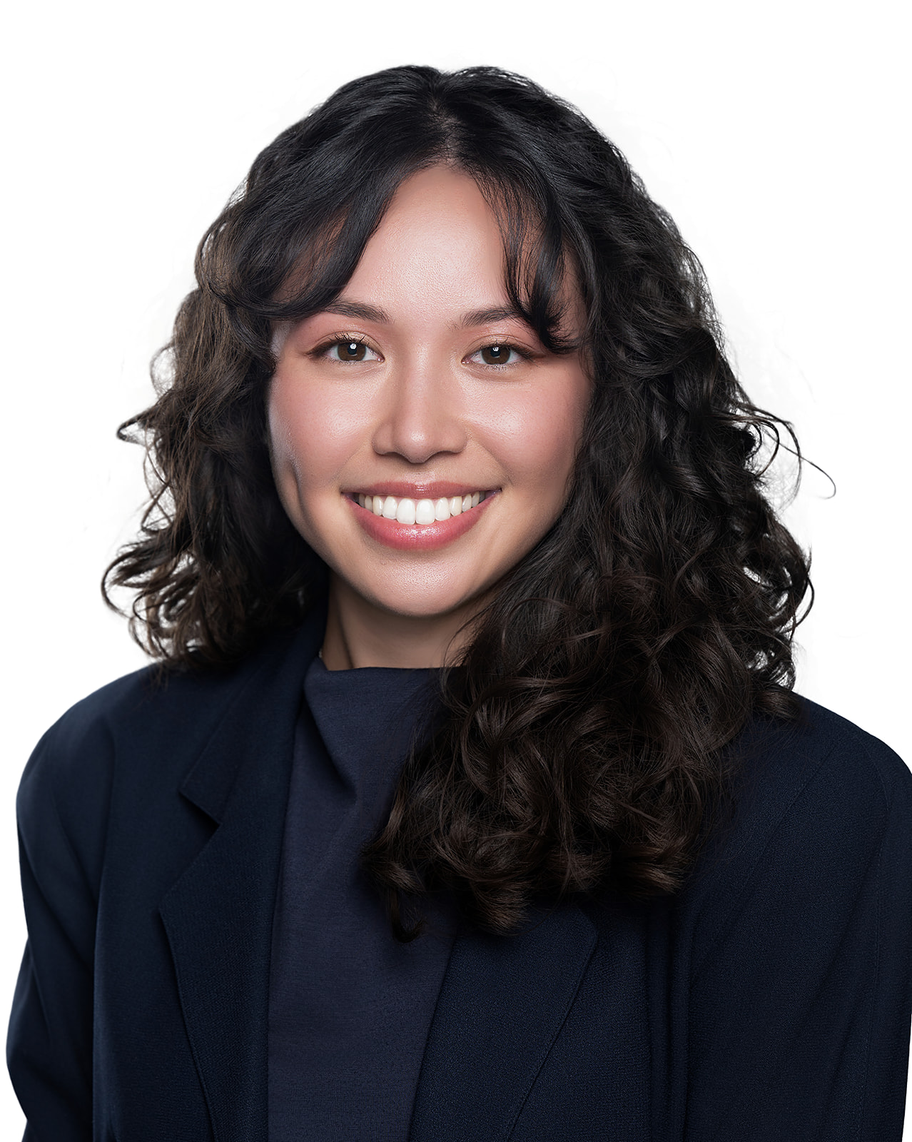 Professional studio headshot of a woman in a navy blazer on white backdrop