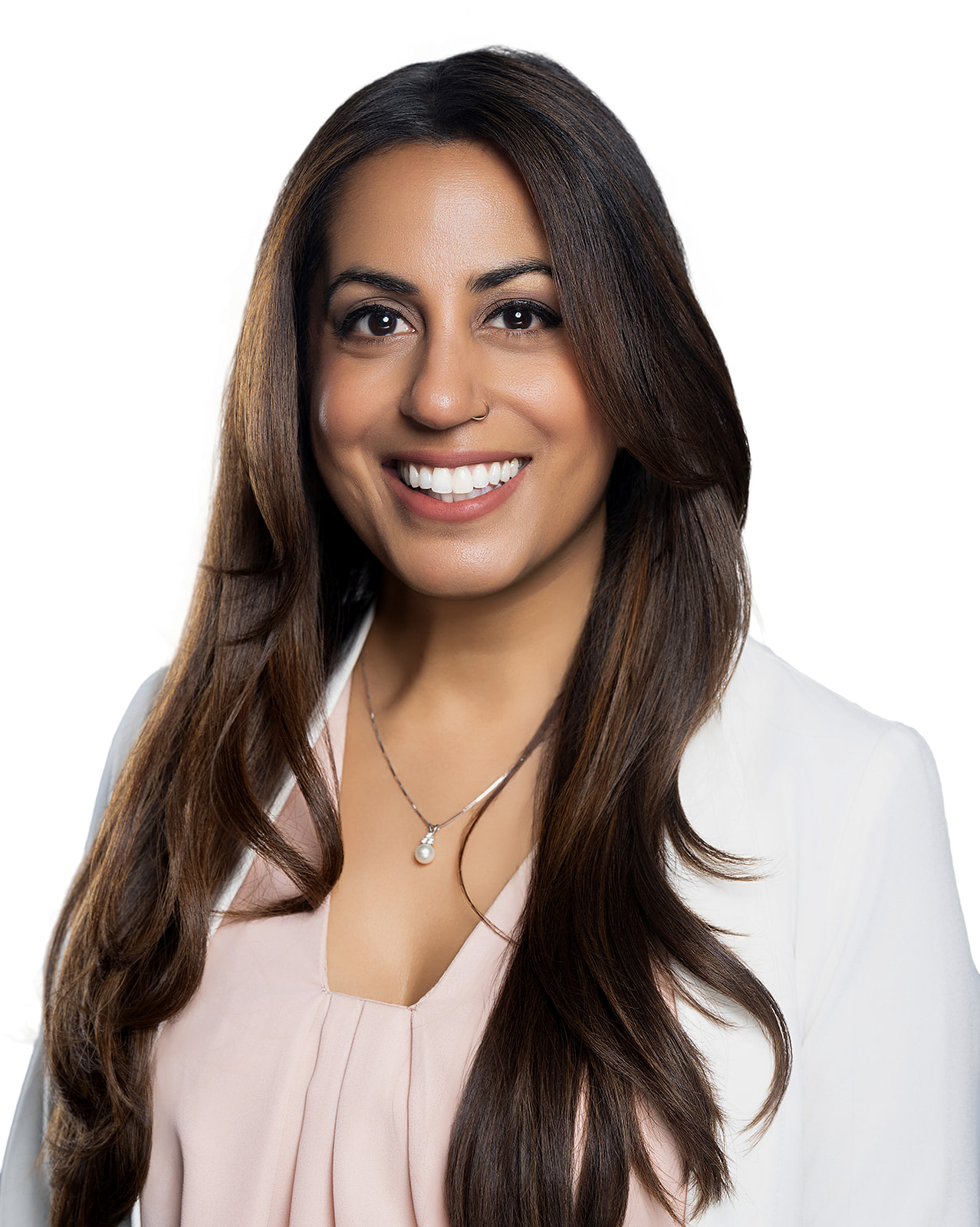 Professional studio headshot of a woman in a white blazer and blush blouse