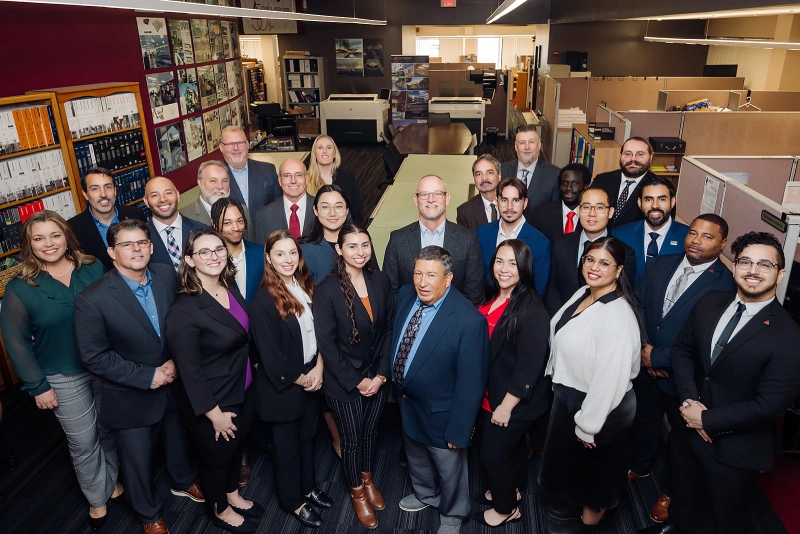 Large corporate team group portrait inside a modern office