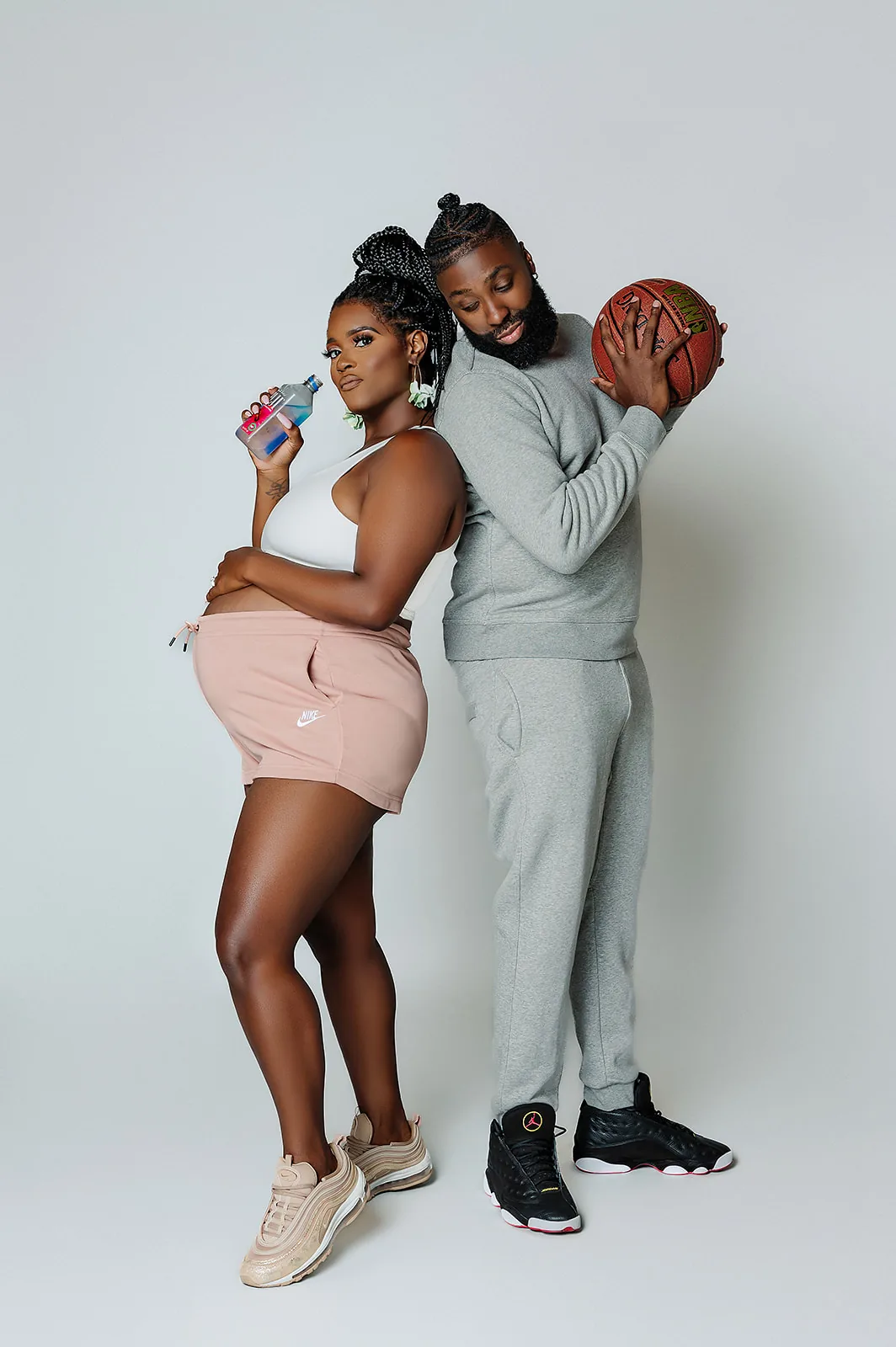Maternity couple portrait — sporty athleisure with basketball