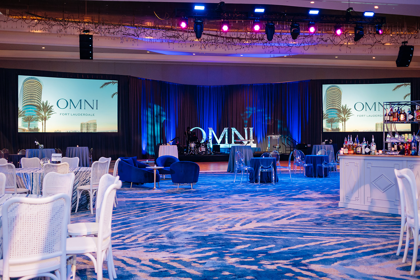 Corporate event stage and lounge setup at Omni Fort Lauderdale in South Florida