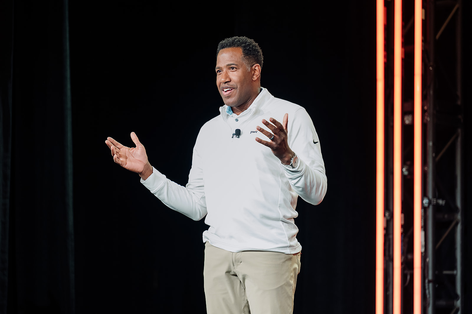 PwC executive keynote speaker on main stage at corporate conference