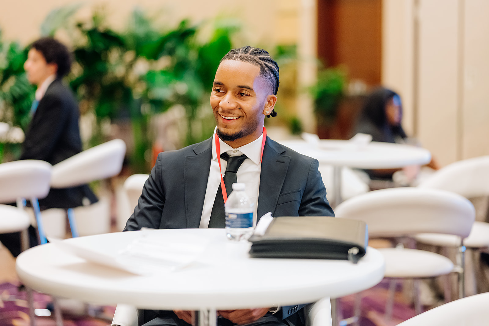 PwC WIN conference attendee smiling at networking table