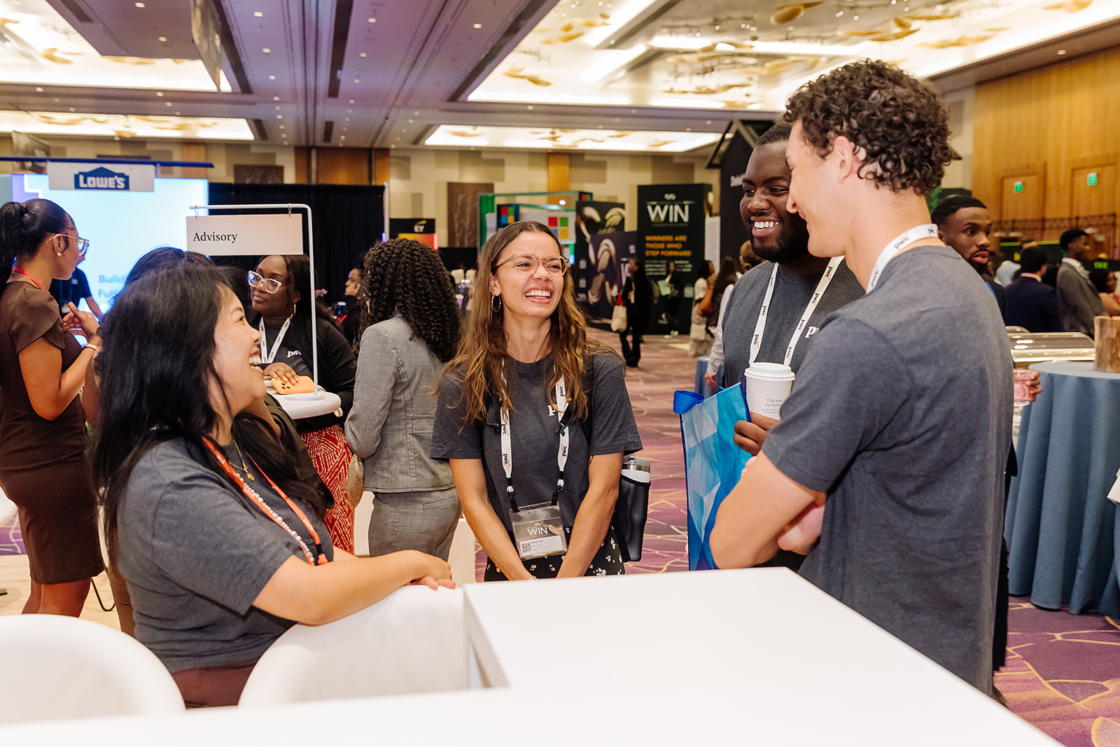 PwC WIN conference attendees networking on the expo floor