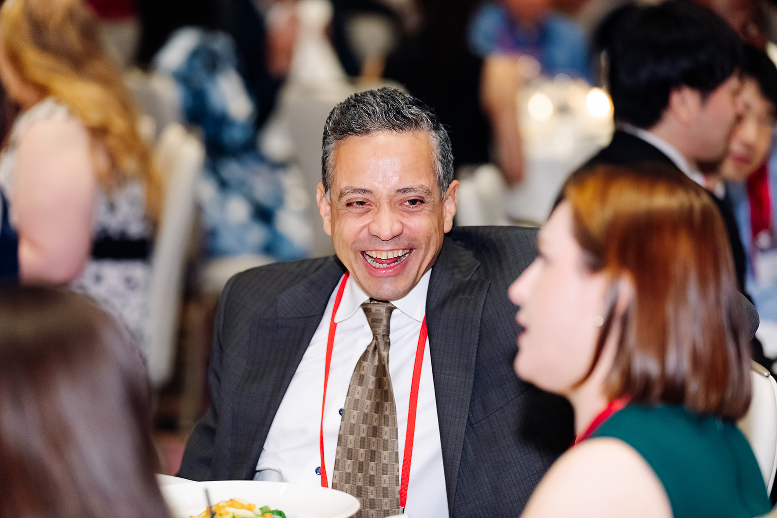Attendee laughing at Shock Society awards gala dinner in Las Vegas