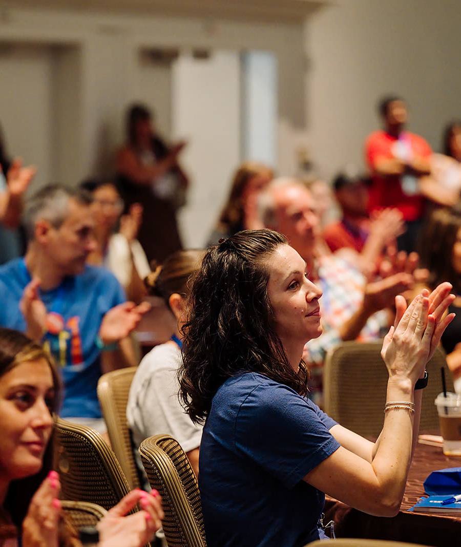 Conference audience applauding at the close of a keynote presentation