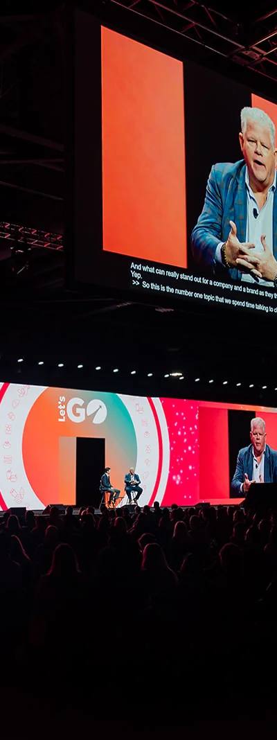 Wide shot of GoTo Foods Let's Go main stage fireside chat with IMAG screens at the Georgia World Congress Center in Atlanta