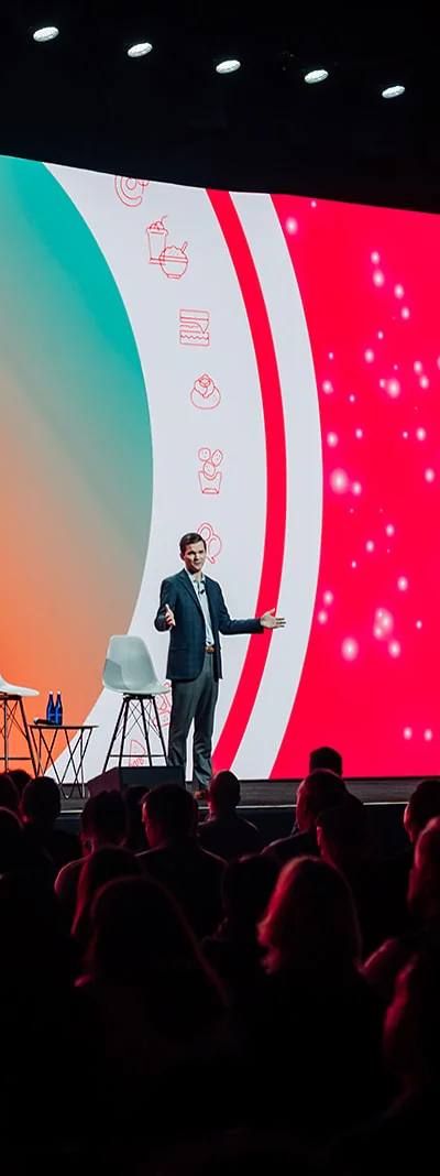 Keynote speaker on the Let's Go main stage with IMAG screen at the GoTo Foods conference in Atlanta
