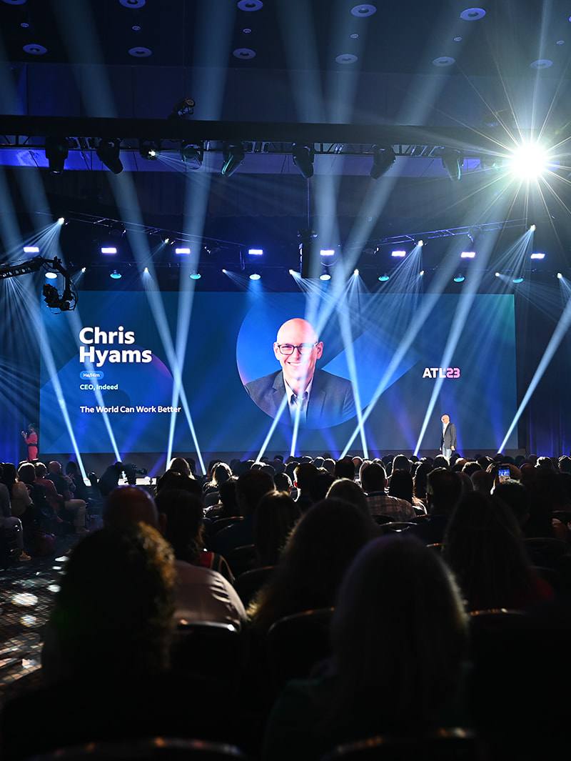 Indeed CEO Chris Hyams keynote at ATL23 conference with dramatic stage lighting in Atlanta