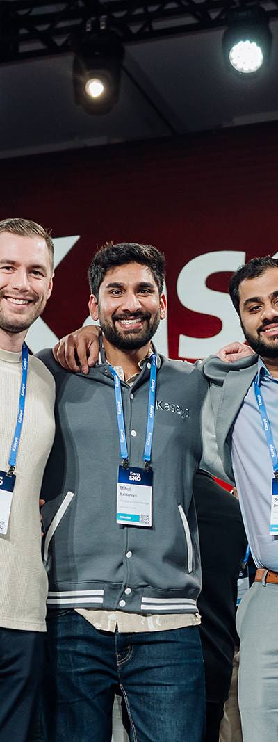 Group of Kaseya SKO attendees posing together on stage in Miami