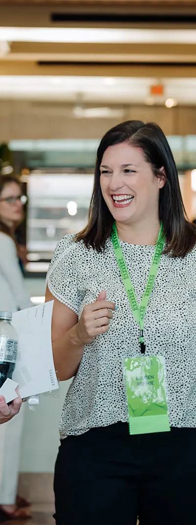 Two Foundant Summit attendees laughing together in the hotel lobby during a networking break in Tampa